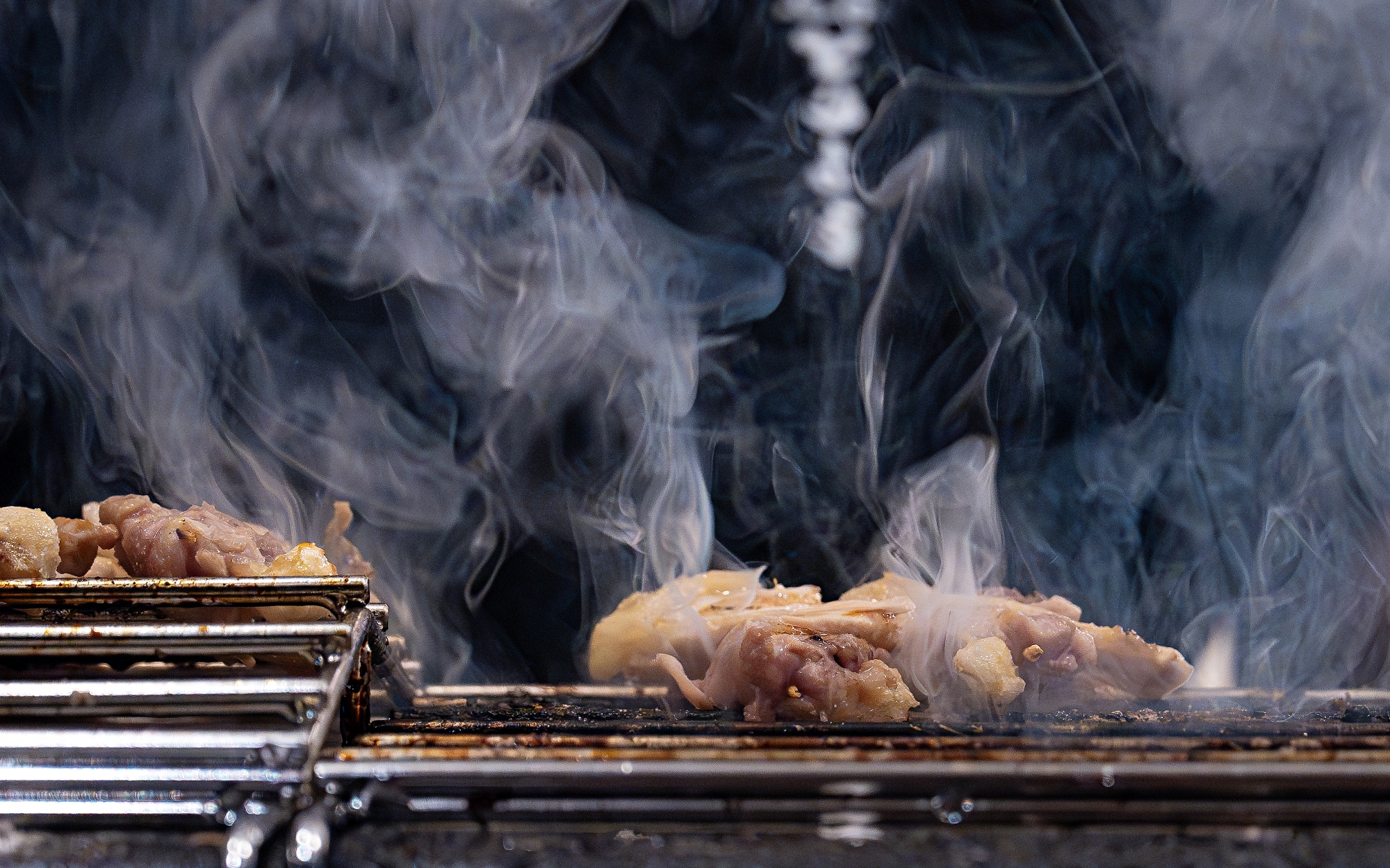 Toriyowoo yakitori skewers sizzling over charcoal in Seochon