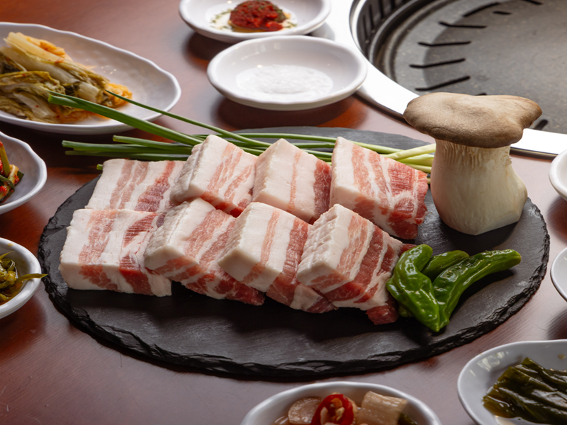 Choilyuk staff grilling premium cuts over natural charcoal