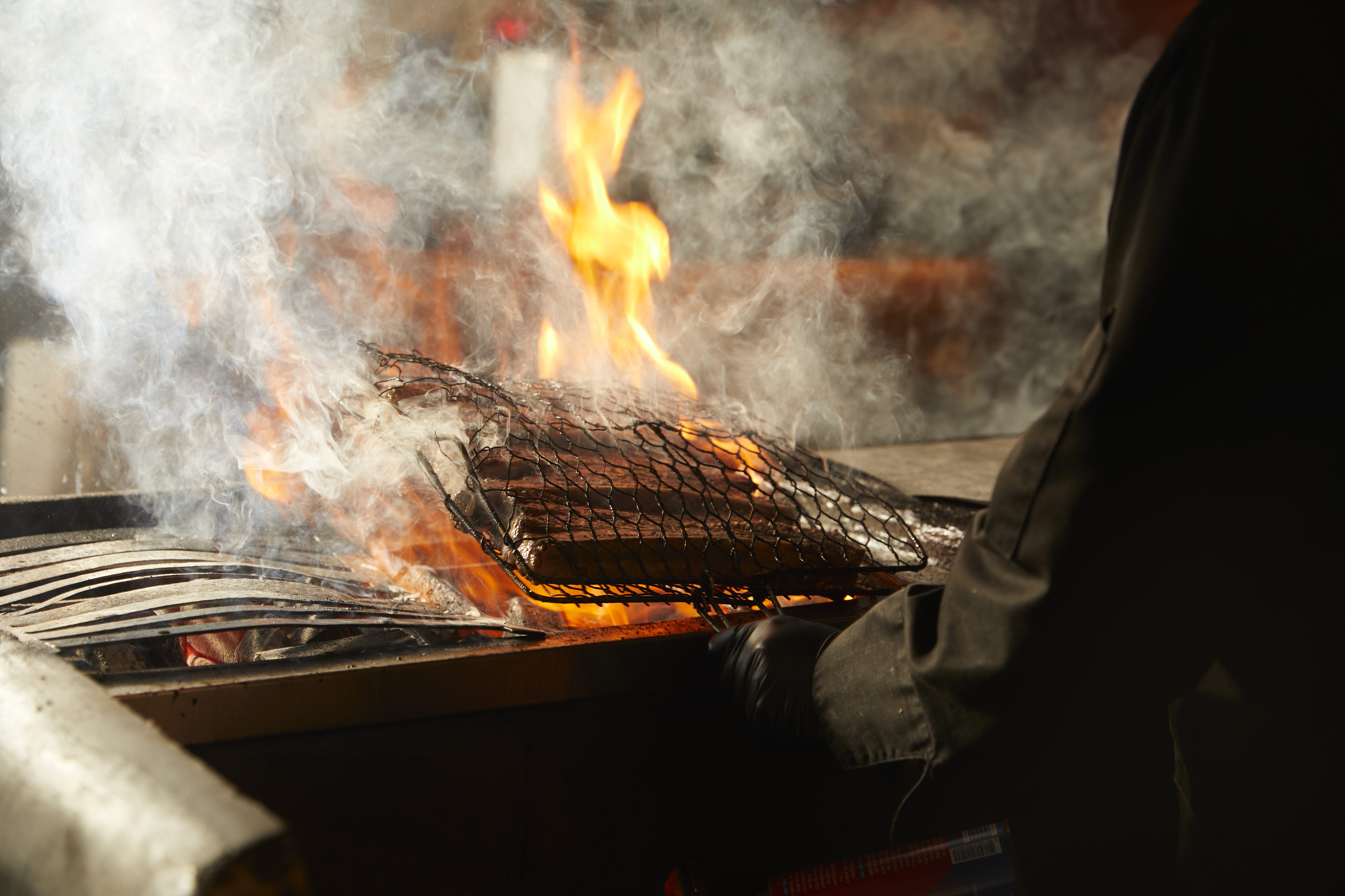 Mongtan's straw-smoked short ribs sizzling over ember